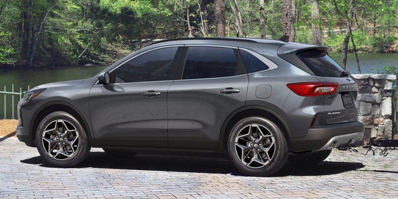 Gray Ford Escape SUV parked beside a lakeside setting.